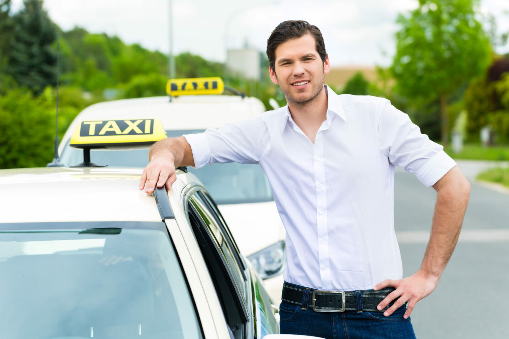 Ein lächelnder Mann lehnt an einem Taxi, ideal für GPS Ortung zur effizienten Fahrzeugortung.
